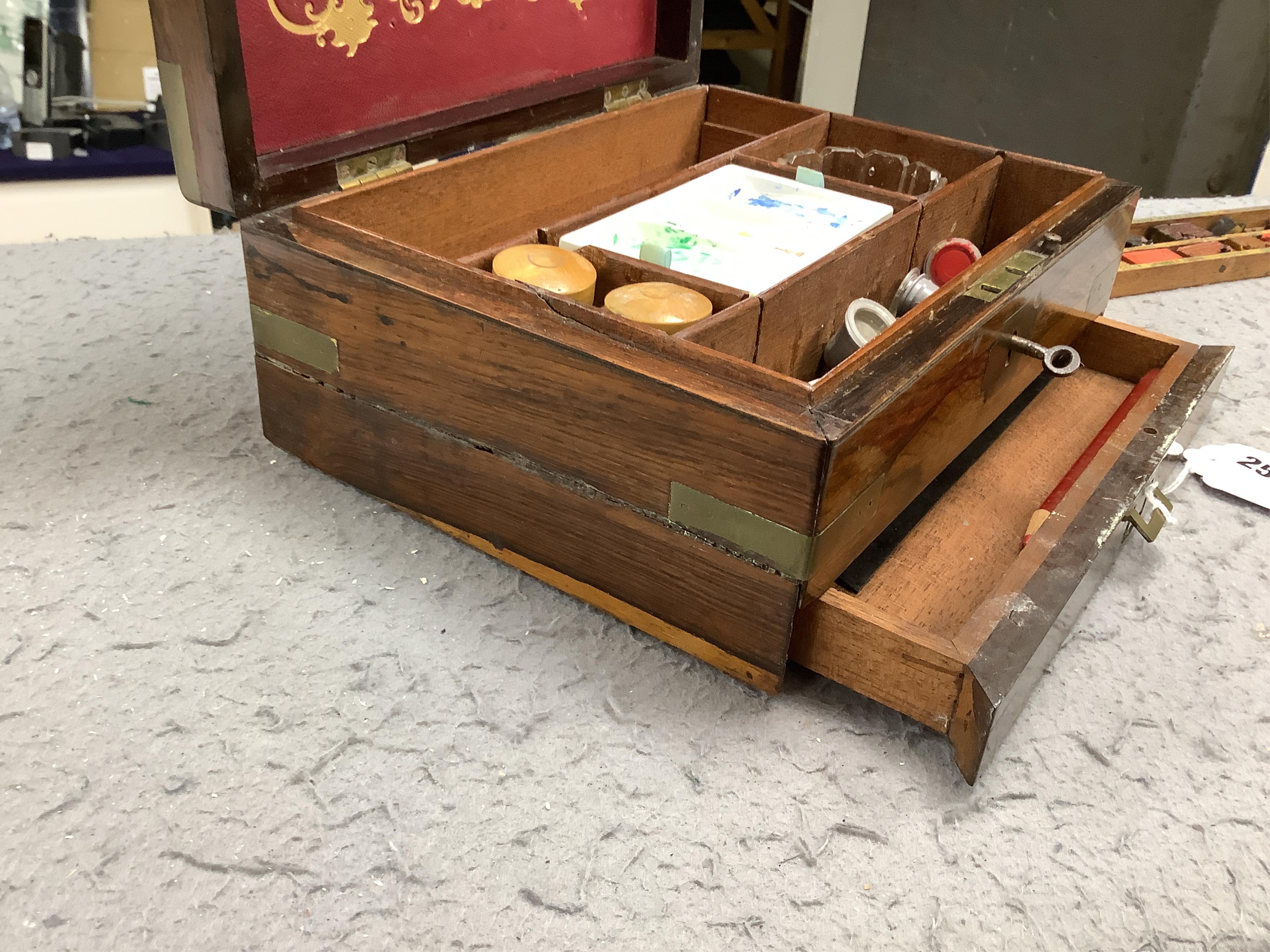 An Edwardian G Rowney & Co brass mounted artist’s paint box with watercolour blocks, tubes and charcoal sticks